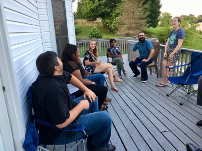 Picture of a group of graduate students laughing at a summer cookout.