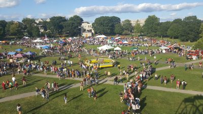 Aerial picture of Gobblerfest showing hundreds of people milling around the Drillfield green space.